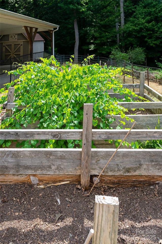 exterior details featuring fence and a garden