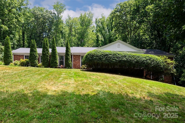 ranch-style home with a front lawn and brick siding