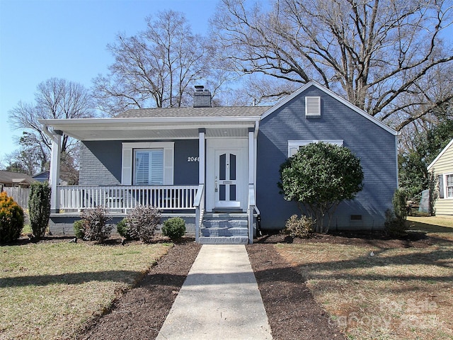 bungalow-style house with brick siding, a chimney, crawl space, a porch, and a front yard