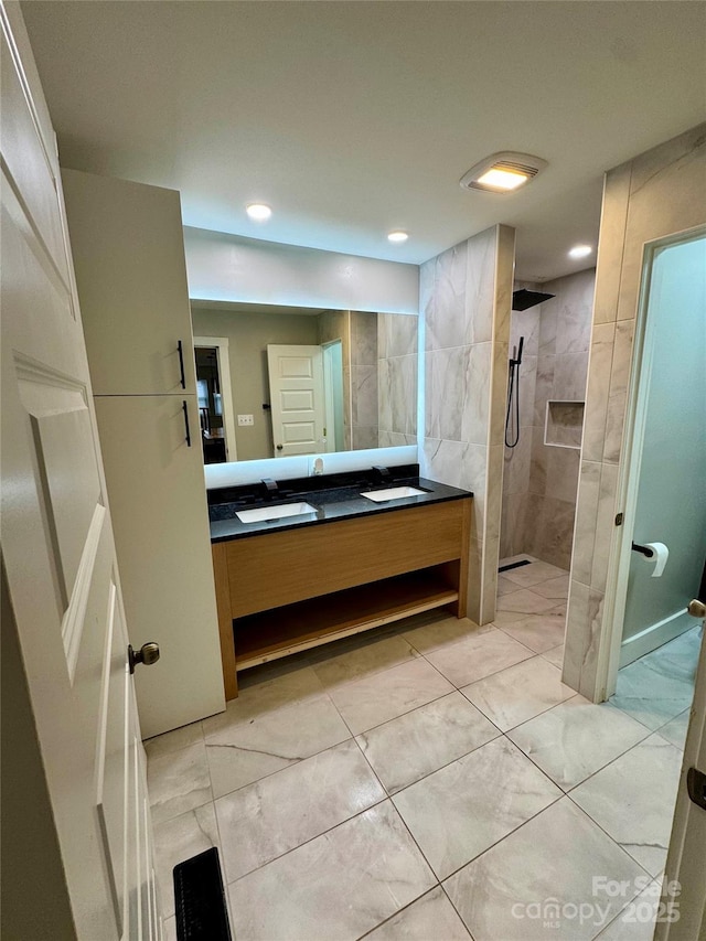 full bath with a walk in shower, marble finish floor, vanity, and recessed lighting