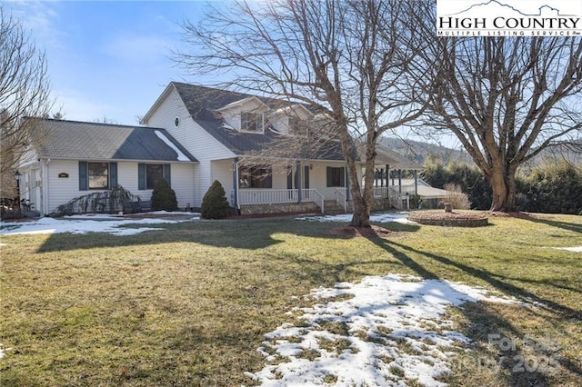 view of front of home with a porch and a front yard