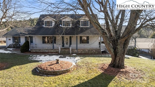 cape cod home featuring covered porch and a front lawn