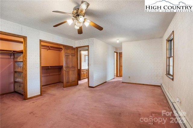 unfurnished bedroom featuring a baseboard radiator, a textured ceiling, and light colored carpet