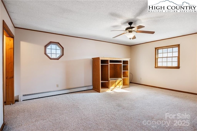 carpeted spare room with a textured ceiling, a baseboard radiator, a ceiling fan, and crown molding