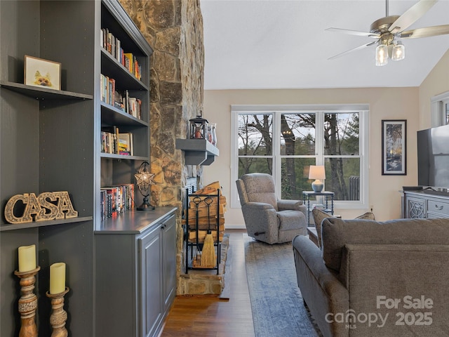 living room with vaulted ceiling, wood finished floors, and ceiling fan