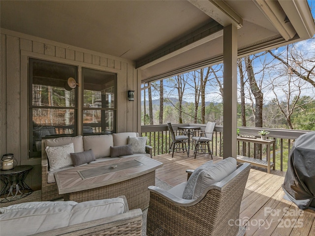 wooden terrace featuring an outdoor hangout area