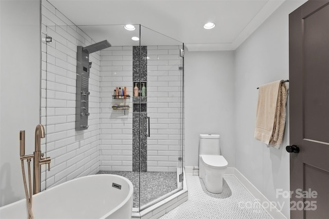 bathroom with toilet, baseboards, a freestanding bath, a shower stall, and tile patterned floors