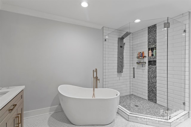 bathroom with a stall shower, vanity, and baseboards