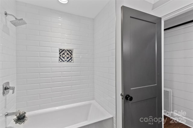 full bathroom with  shower combination and visible vents