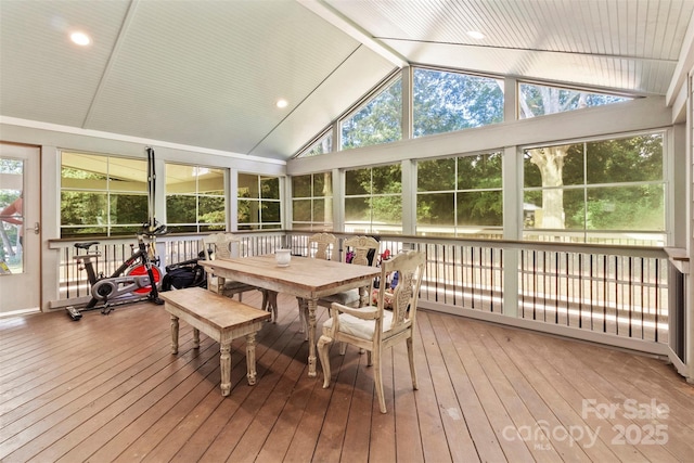 sunroom with a wealth of natural light and lofted ceiling