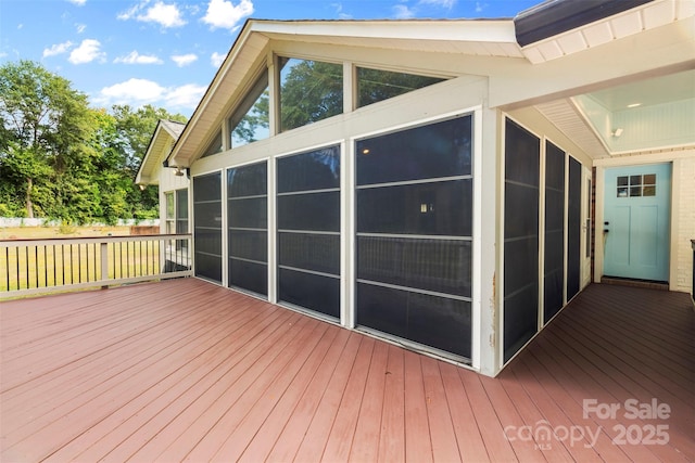 wooden deck with a sunroom