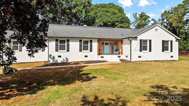 ranch-style home featuring crawl space, roof with shingles, a front yard, and brick siding