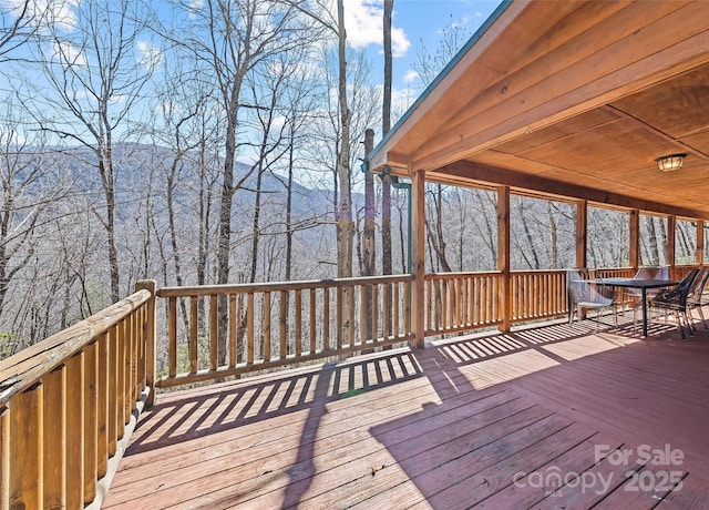 wooden terrace with outdoor dining area