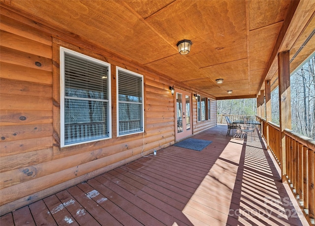 wooden terrace featuring outdoor dining space