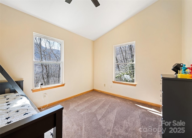 carpeted bedroom featuring ceiling fan, baseboards, and vaulted ceiling