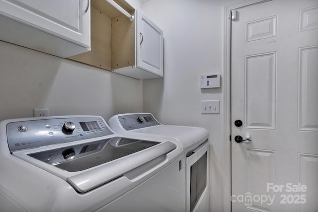 washroom with independent washer and dryer and cabinet space