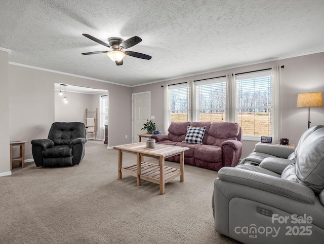 living room featuring crown molding, light colored carpet, ceiling fan, a textured ceiling, and baseboards