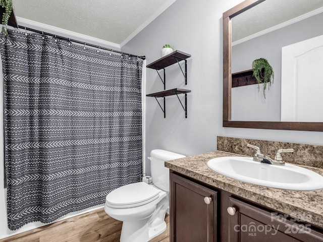 full bath featuring ornamental molding, a textured ceiling, vanity, and wood finished floors