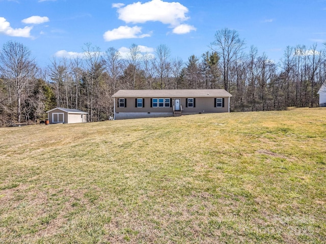 view of front of house with an outbuilding, a front lawn, and a detached garage