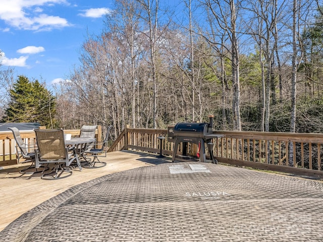 wooden terrace with grilling area and outdoor dining area