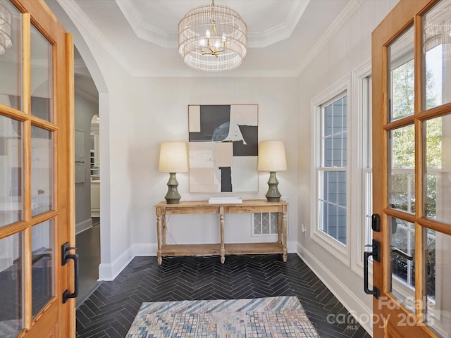 home office featuring arched walkways, a tray ceiling, crown molding, a notable chandelier, and baseboards