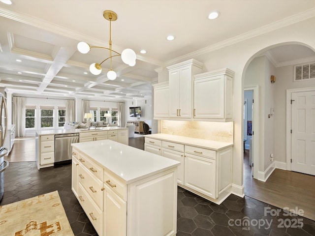 kitchen featuring arched walkways, coffered ceiling, a kitchen island, visible vents, and stainless steel dishwasher