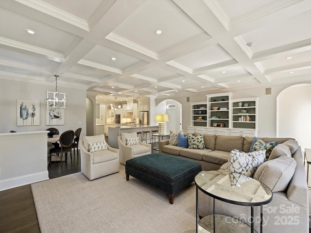 living room featuring light wood-type flooring, arched walkways, beam ceiling, and recessed lighting