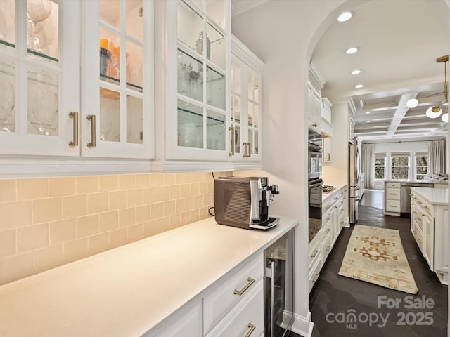 kitchen featuring recessed lighting, beverage cooler, coffered ceiling, white cabinetry, and decorative backsplash