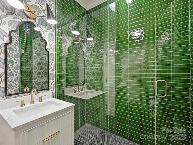 full bath featuring a shower stall, vanity, and crown molding