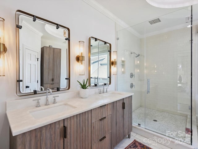 bathroom featuring crown molding, visible vents, a sink, and a shower stall