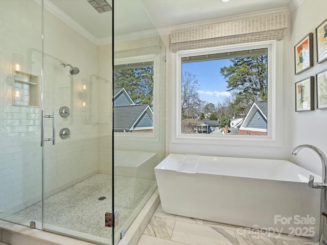 bathroom with a stall shower, marble finish floor, a freestanding tub, and crown molding