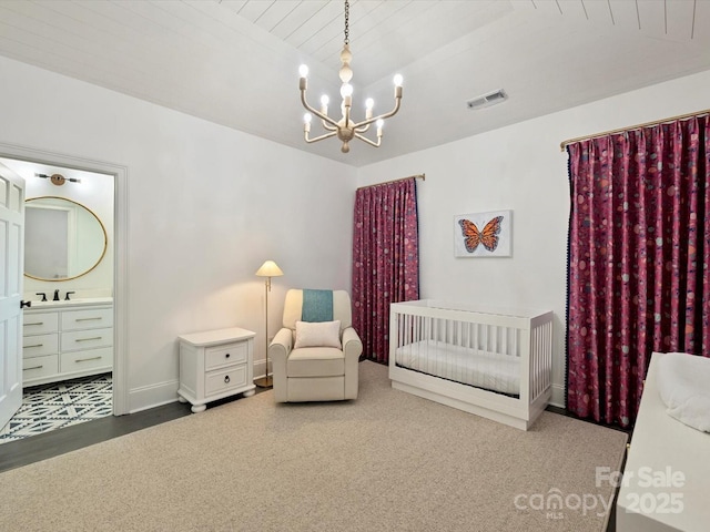 bedroom featuring visible vents, an inviting chandelier, connected bathroom, wooden ceiling, and baseboards