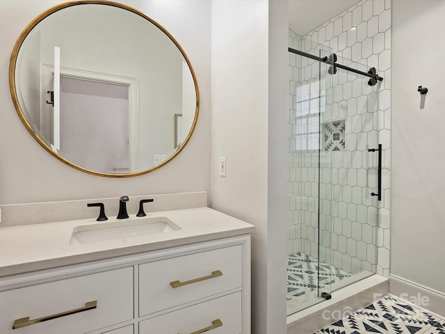 bathroom with a shower stall and vanity