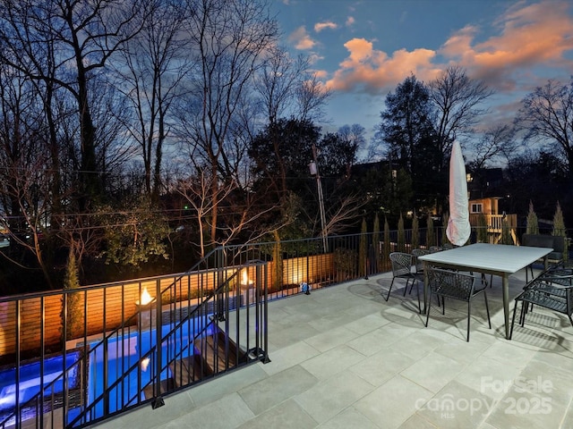 view of swimming pool featuring a fenced in pool, outdoor dining area, fence, and a patio