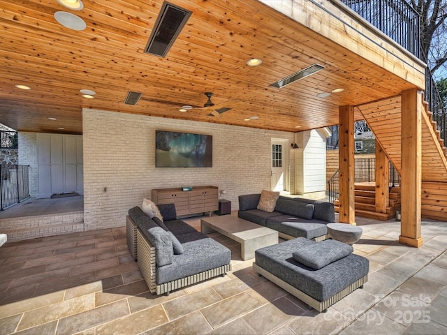 view of patio featuring an outdoor hangout area, stairway, and a ceiling fan