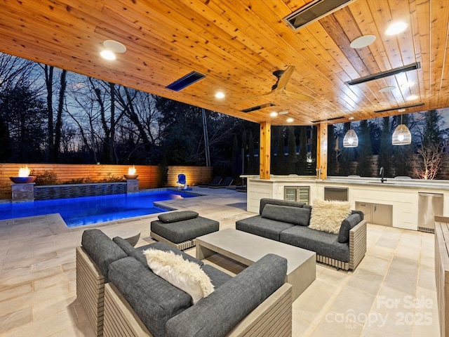 view of patio featuring a fenced backyard, a sink, an outdoor living space, and a fenced in pool