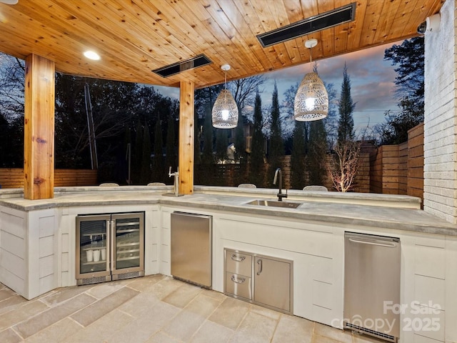 view of patio / terrace featuring exterior kitchen, wine cooler, visible vents, and a sink