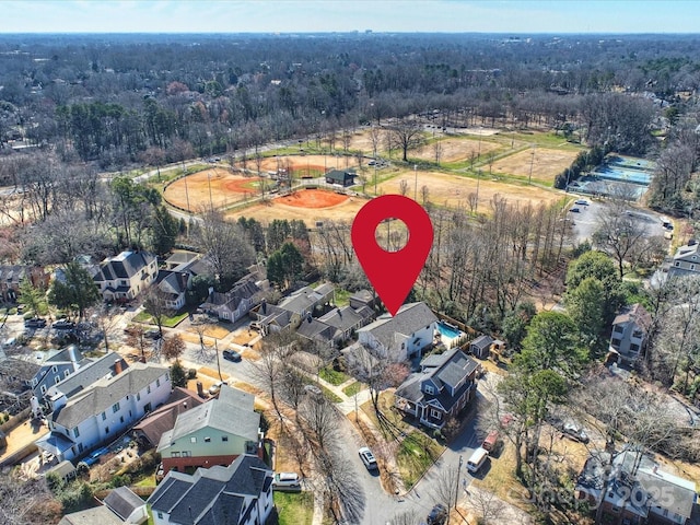 drone / aerial view with a wooded view and a residential view