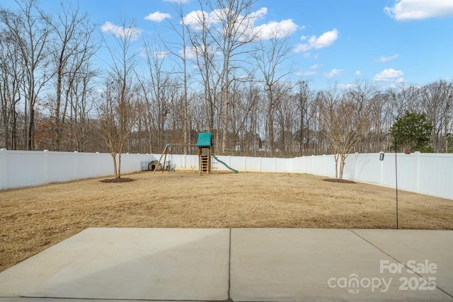 view of yard with a patio area, a fenced backyard, and playground community