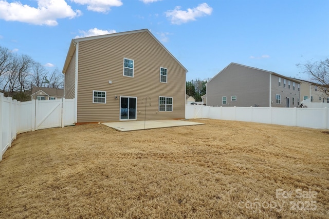 back of property featuring a yard, a patio area, and a fenced backyard