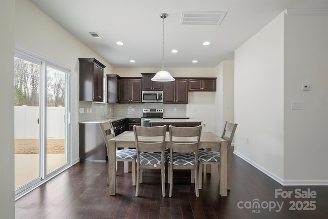 dining area with recessed lighting, baseboards, visible vents, and dark wood-style flooring