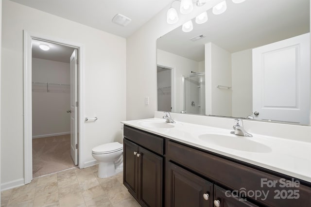 bathroom with visible vents, a shower stall, toilet, and a sink