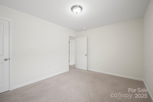 unfurnished bedroom featuring carpet and baseboards