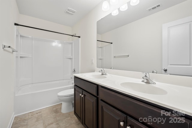 bathroom featuring toilet, visible vents, and a sink