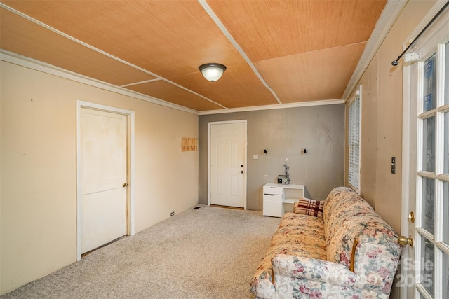 living area with wooden ceiling, carpet floors, and ornamental molding