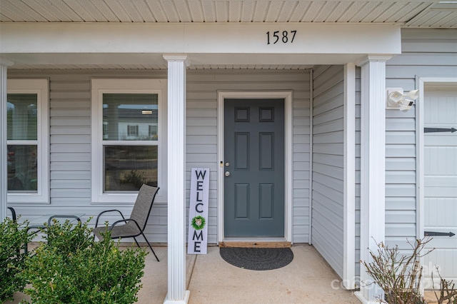 view of exterior entry with a porch