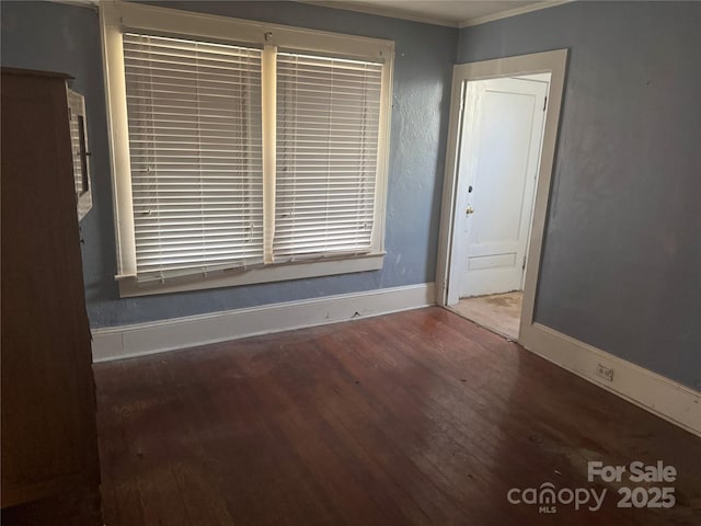 unfurnished room with wood finished floors and baseboards