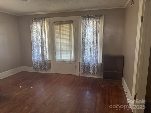 entrance foyer with baseboards, crown molding, visible vents, and hardwood / wood-style floors