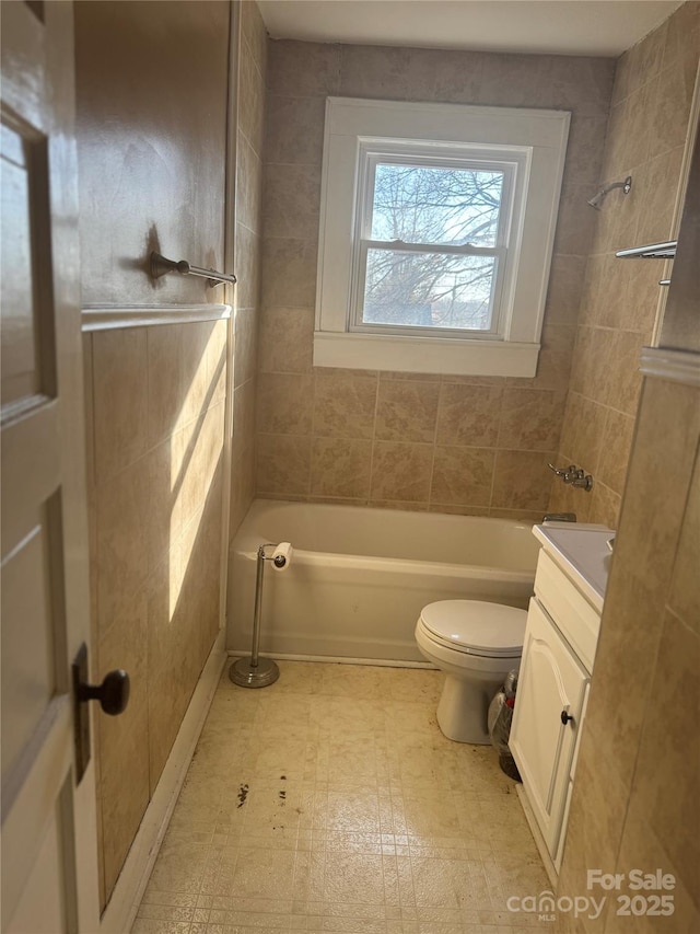 bathroom featuring washtub / shower combination, vanity, toilet, and tile patterned floors