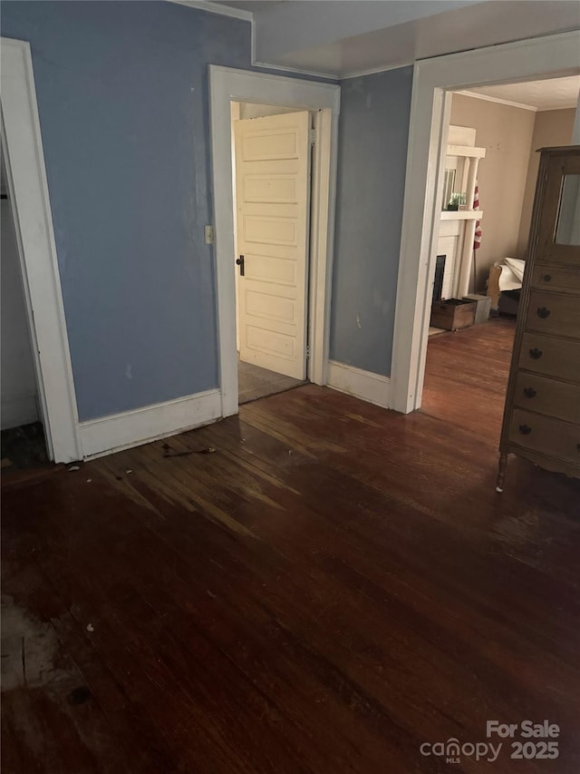 unfurnished bedroom featuring wood finished floors and baseboards